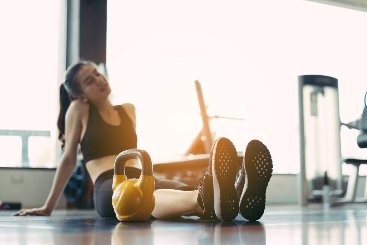 Young girl showing strong biceps after outdoors fitness workout