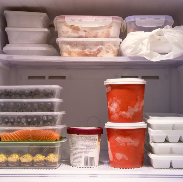 full of frozen food in refrigerator. meat, fish, fruit, chocolate, ice and bucket container ice creams flavors on freezer shelves. stocks of meal and get ready for summer.