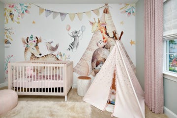 a baby crib with a white canopy and a pink curtain