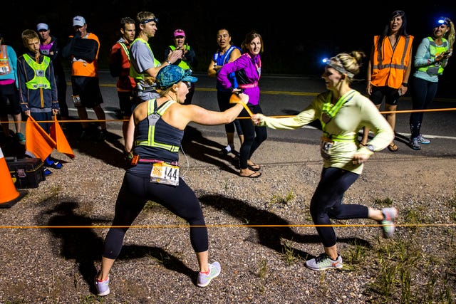 women exchanging a baton
