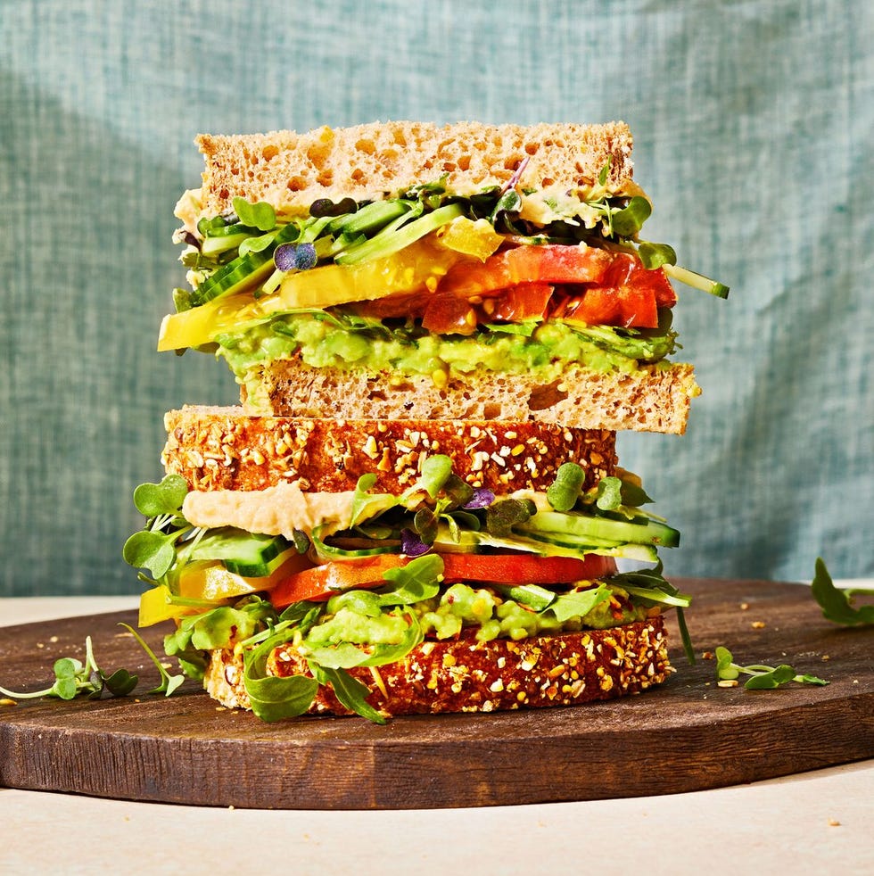 veggie sandwich with avocado, hummus tomato, and cucumber