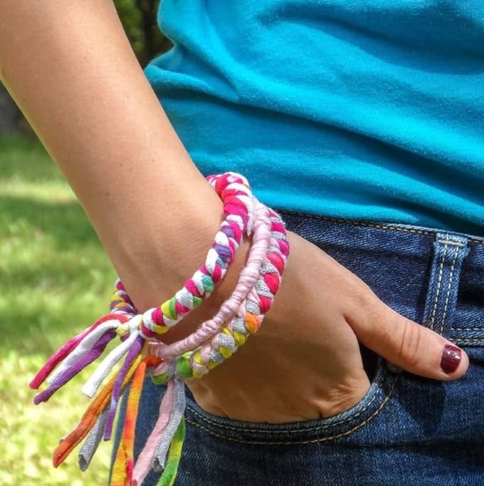 A woman wearing a bracelet made from recycled T-shirts