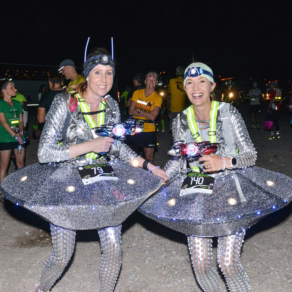 two runners dressed in ufo costumes at the et full moon half marathon