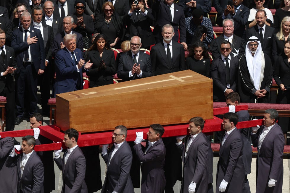 coffin being carried during a solemn event