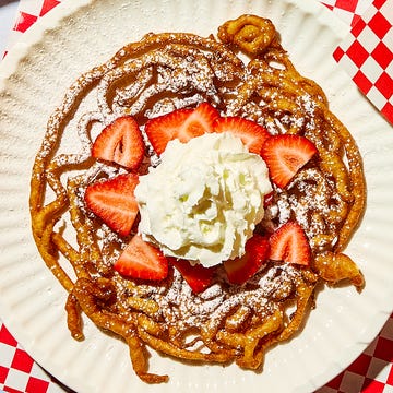 Funnel Cake funnel cake topped with strawberries and powdered sugar