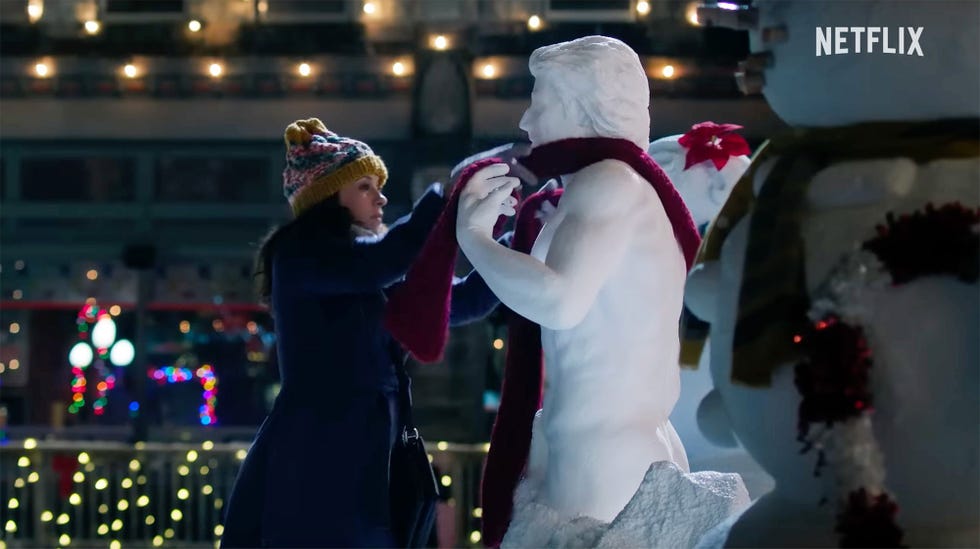 a woman puts a magic scarf on a chiseled ice sculpture in a scene from hot frosty, which is an actual movie that exists