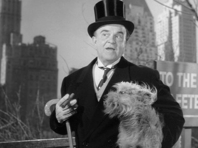 a hobo dresses in a top hat and carries a small dog to seem like a millionaire in a sene from it happened on fifth avenue