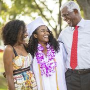 funny graduation quotes family laughing with graduate in the middle
