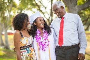 funny graduation quotes family laughing with graduate in the middle