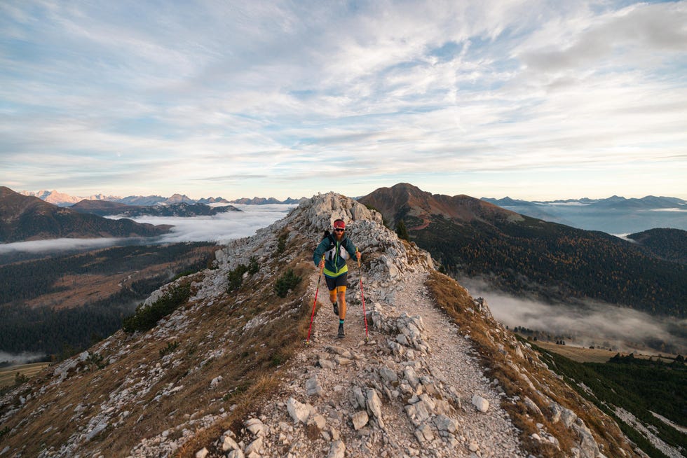 trail running on a mountainous ridge during sunrise