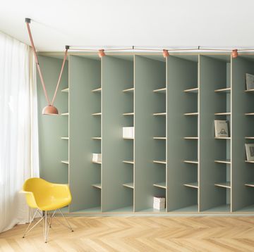 a room with a chair and shelves