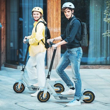 a man and woman on a scooter