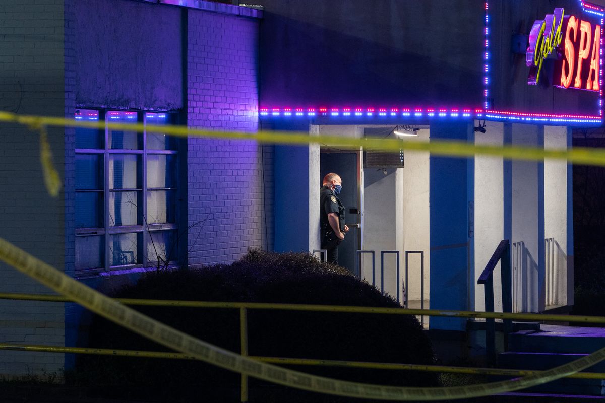 a police officer stands outside a massage parlor where three people were shot and killed on march 16, 2021, in atlanta, georgia   eight people were killed in shootings at three different spas in the us state of georgia on march 16, police and local media reported it is "extremely likely" that the same suspect was involved in all three deadly shootings at spas in the us state of georgia, police told afp tuesday the suspect, named as 21 year old robert aaron long, is in police custody in the violence that reportedly killed eight people photo by elijah nouvelage  afp photo by elijah nouvelageafp via getty images