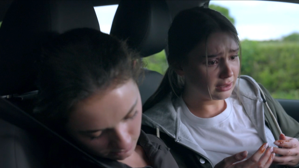 sarah sugden is in shock in the passenger seat, her hands are covered in blood. next to her, gabby thomas has passed out at the wheel on emmerdale