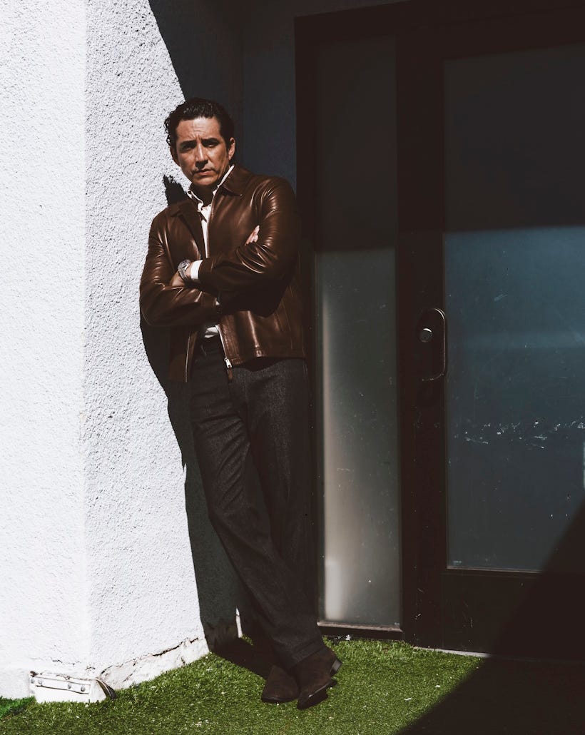 man leaning against a wall beside a glass door