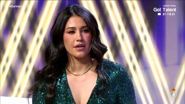 a participant in a sparkling green outfit during a talent show