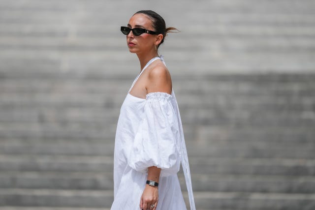 mujer con vestido blanco y gafas de sol