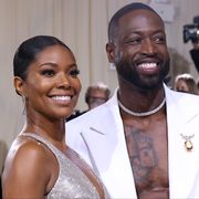 dwayne wade and gabrielle union posing and smiling at the 2022 met gala celebrating "in america an anthology of fashion" arrivals