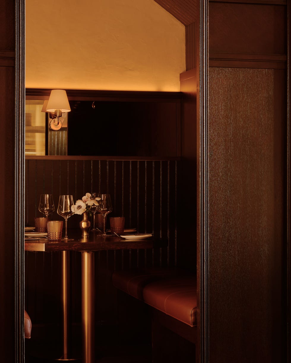 a dining booth with partitioned sides to create a semi private dining area