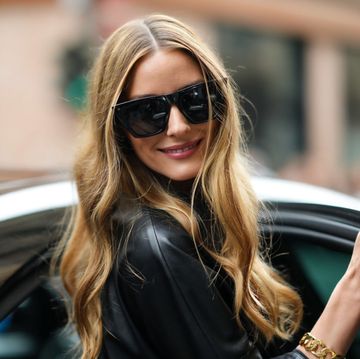 milan, italy september 25 olivia palermo wears black sunglasses, earrings, a black oversized belted midi leather dress with leather cut out flower pattern yoke, outside the ermanno scervino fashion show during the milan fashion week spring  summer 2022 on september 25, 2021 in milan, italy photo by edward berthelotgetty images