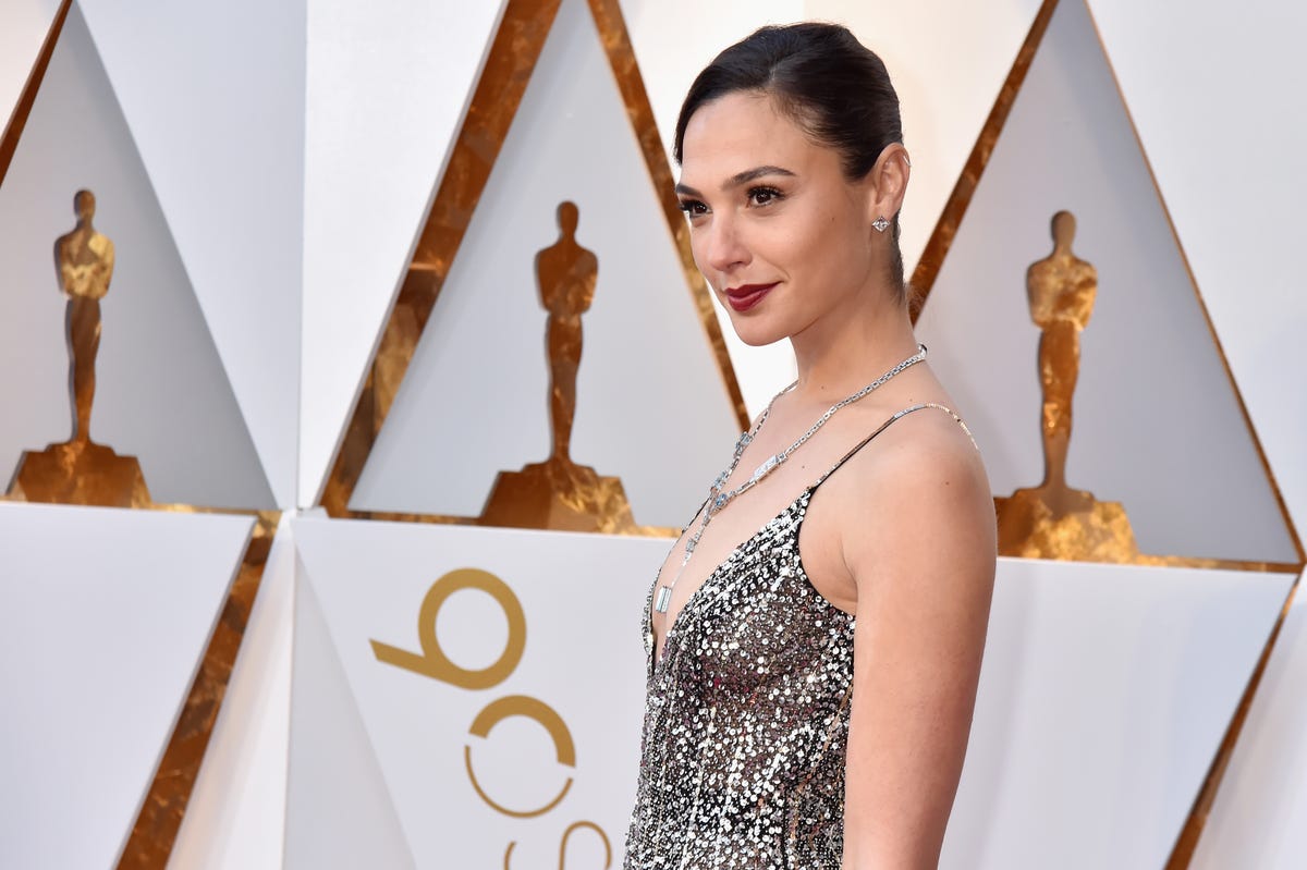 gal gadot in a silver sparkly dress at the 90th annual academy awards