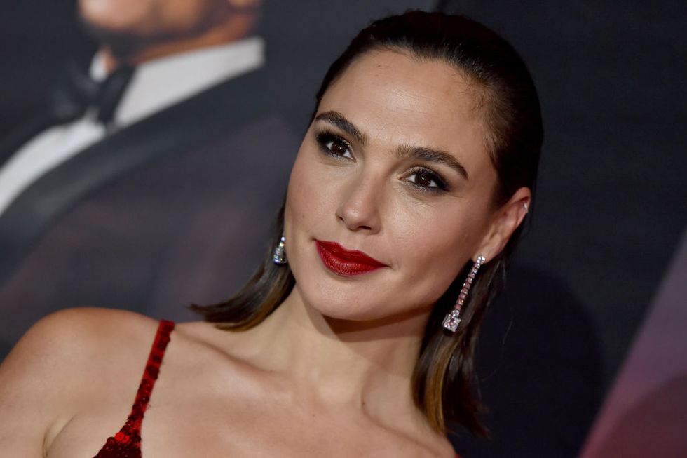 gal gadot in a red dress and red lip at the world premiere of netflix's "red notice"