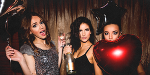 a group of women holding a heart balloon