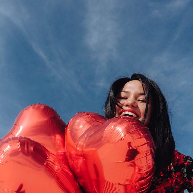girl with red heart balloons