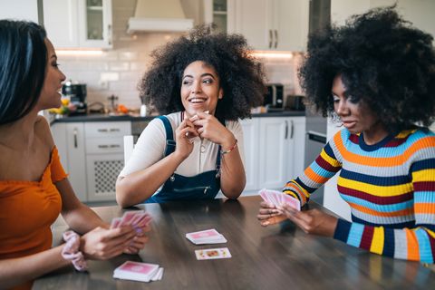 galentines day ideas, three girls at home playing cards