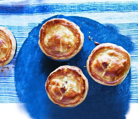 a close up of beef and guinness pies on a blue table