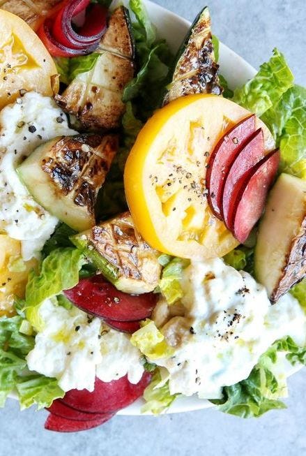 heirloom tomato, zucchini and plum salad with burrata