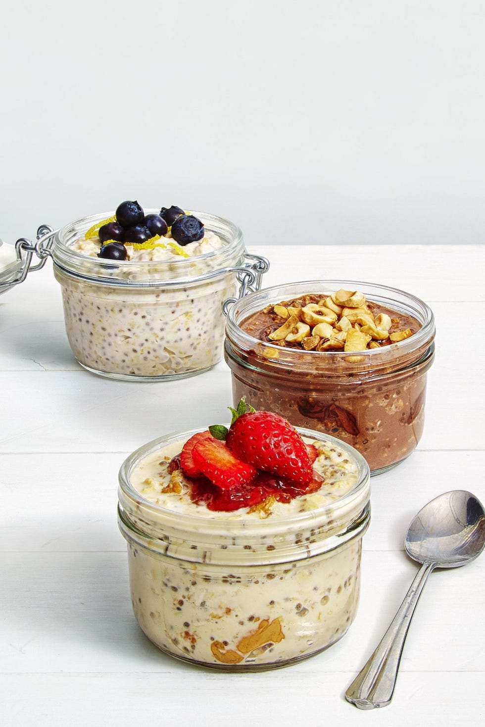 chilled overnight chia seed pudding in a glass container with blueberries on top