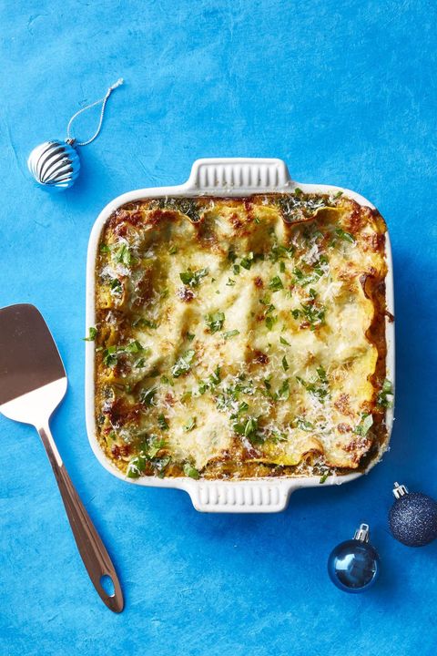 healthy squash and spinach lasagna in a white baking dish