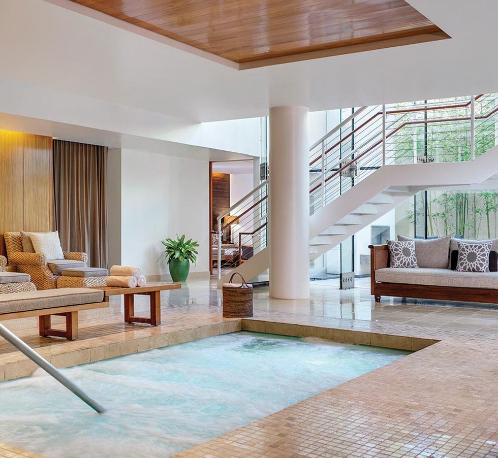 indoor relaxation area featuring a spa pool and seating