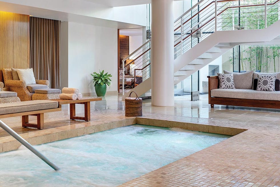 indoor relaxation area featuring a spa pool and seating indoor relaxation area featuring a spa pool and seating