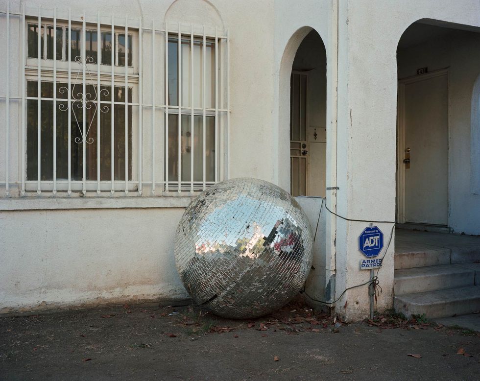 a large metal ball outside a building