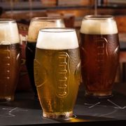 football shaped beer pint glasses and gold game day balloons