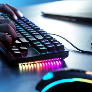 person using keyboard for computer gaming