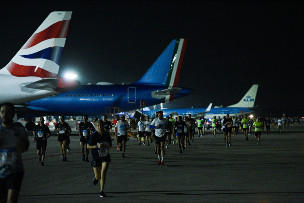 people walking near airplanes