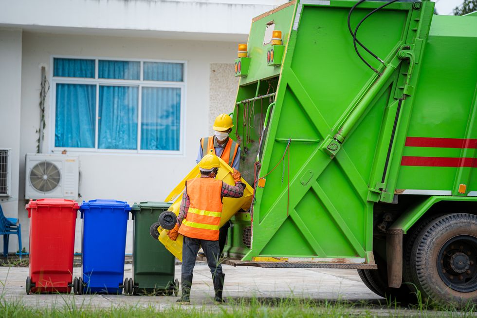garbage removal man loading waste