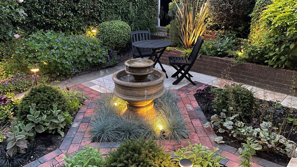 garden path ideas, directional paving, a small courtyard with a fountain and chairs