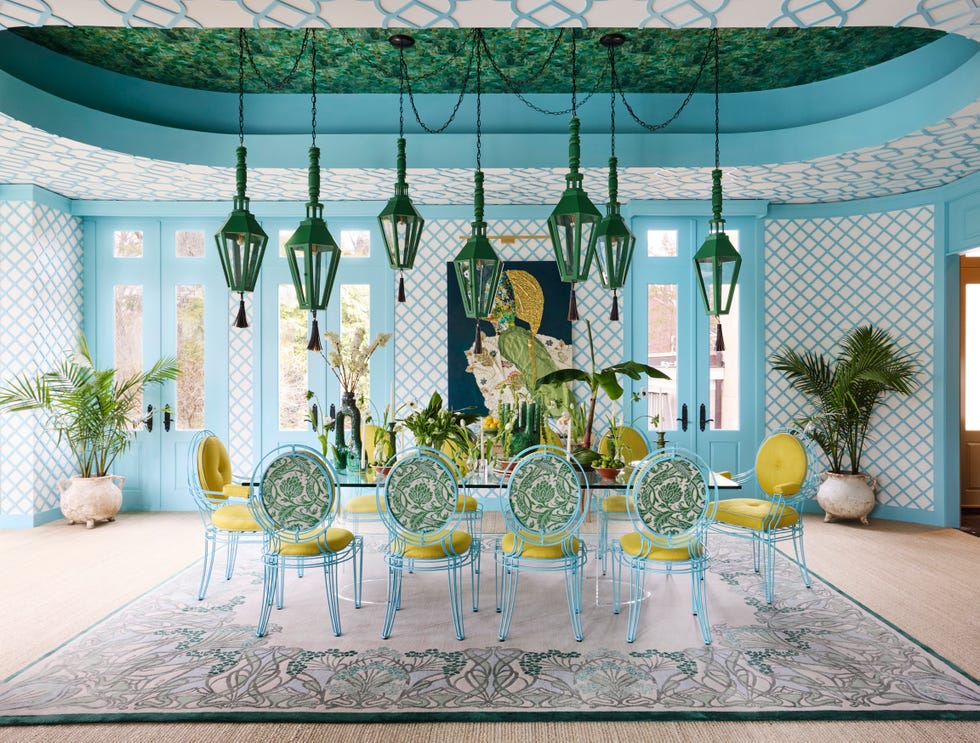 garden room with dining table, blue treillage, and green ceilings and lantern