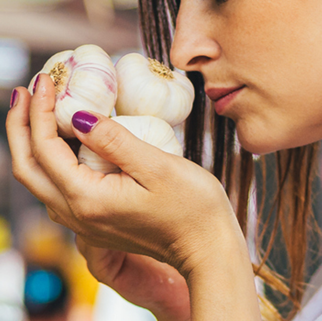 woman up close smelling garlic