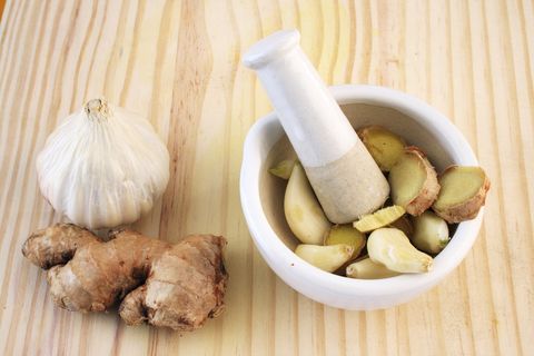 garlic and ginger by a mortar and a pestle