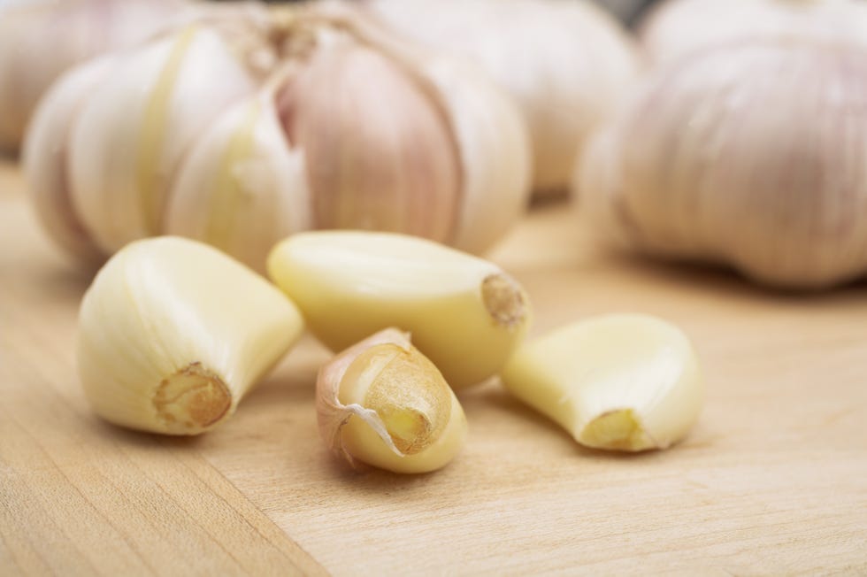 garlic cloves on a wooden board