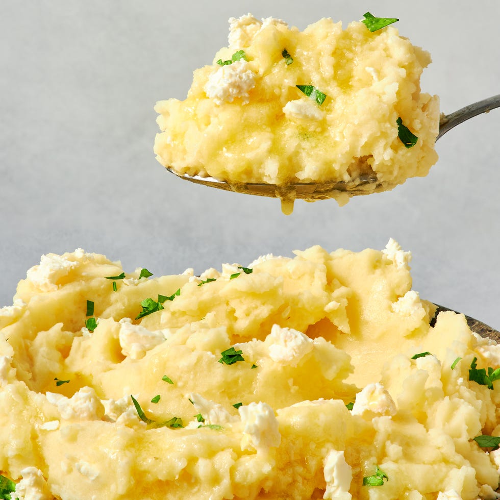 bowl of creamy mashed potatoes topped with feta crumbles