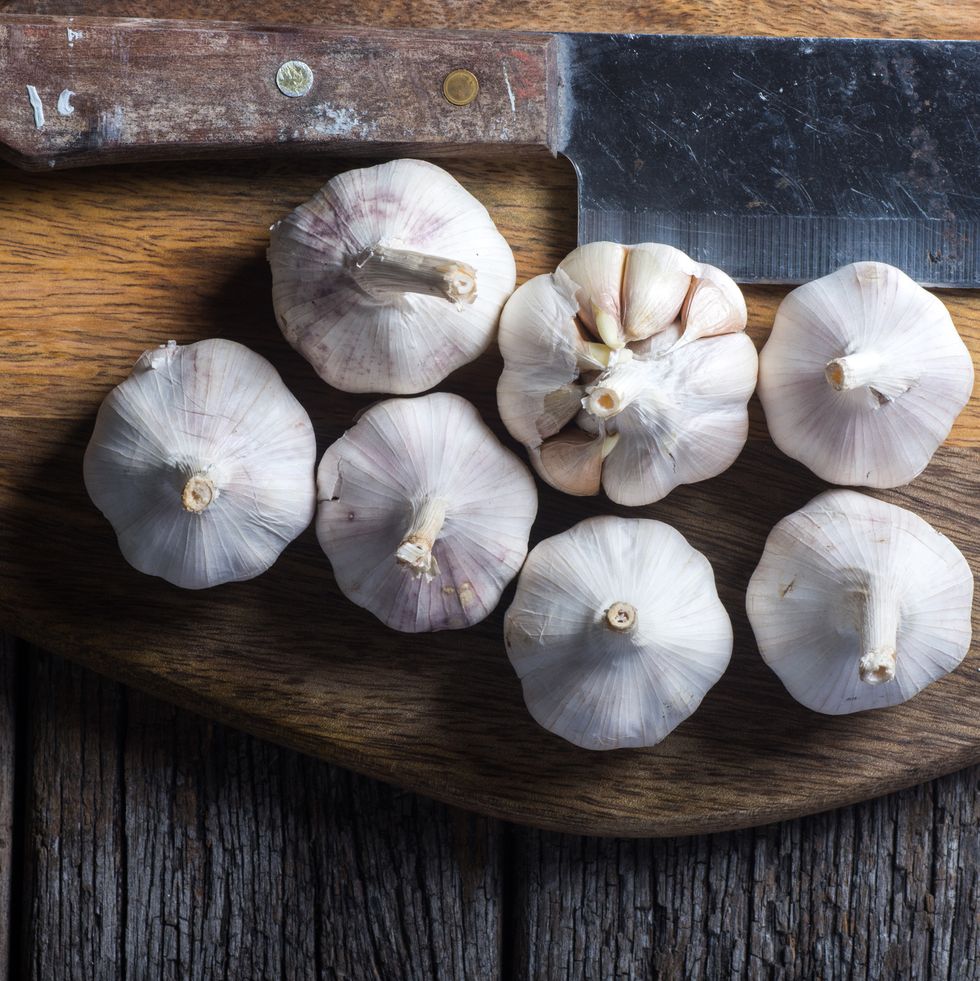 Garlic on wooden chopping board.