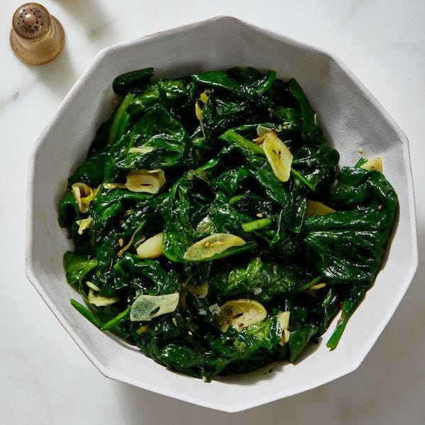 sauteed spinach with garlic and lemon in white bowl
