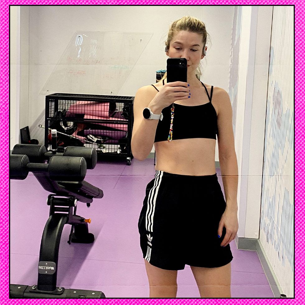 amy taking a selfie in a gym mirror