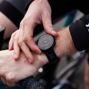 cyclist preparing for a ride and setting smart watch